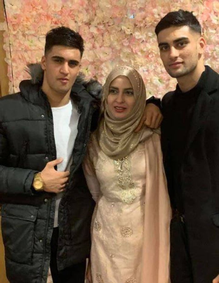 Adam Azim with his mother and brother