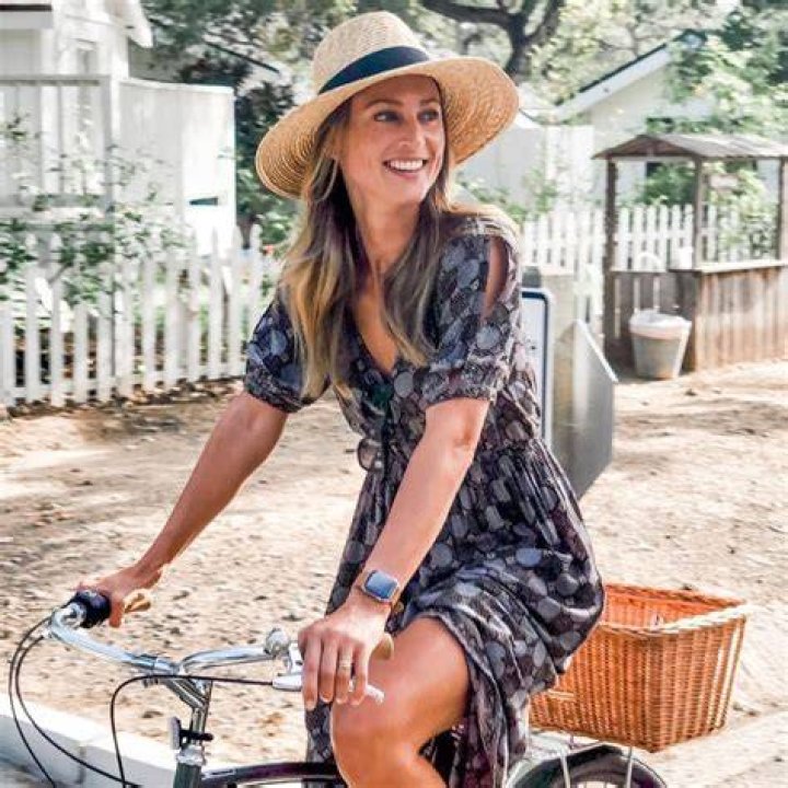 Cassandra Marino riding a bike in a neighborhood