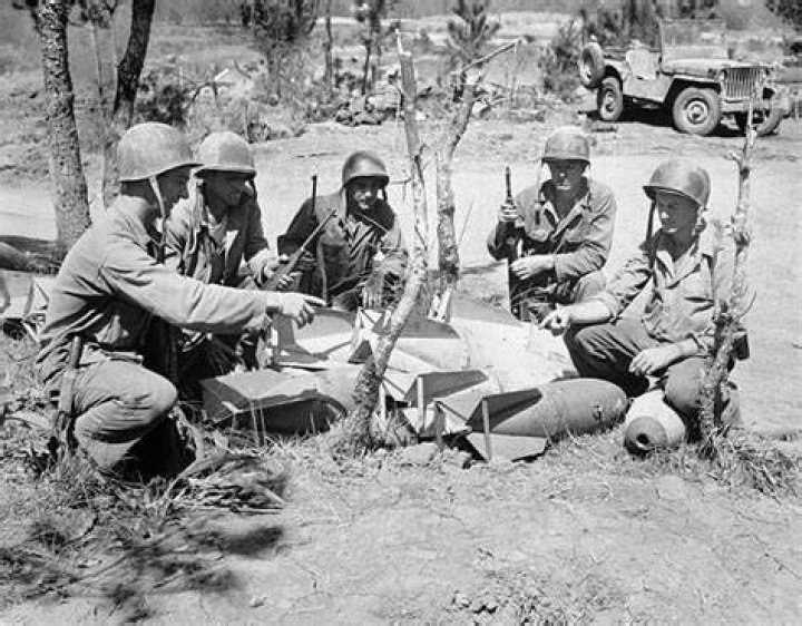 Surviving Soldiers Examine Dead Japanese Bodies At Guadalcanal